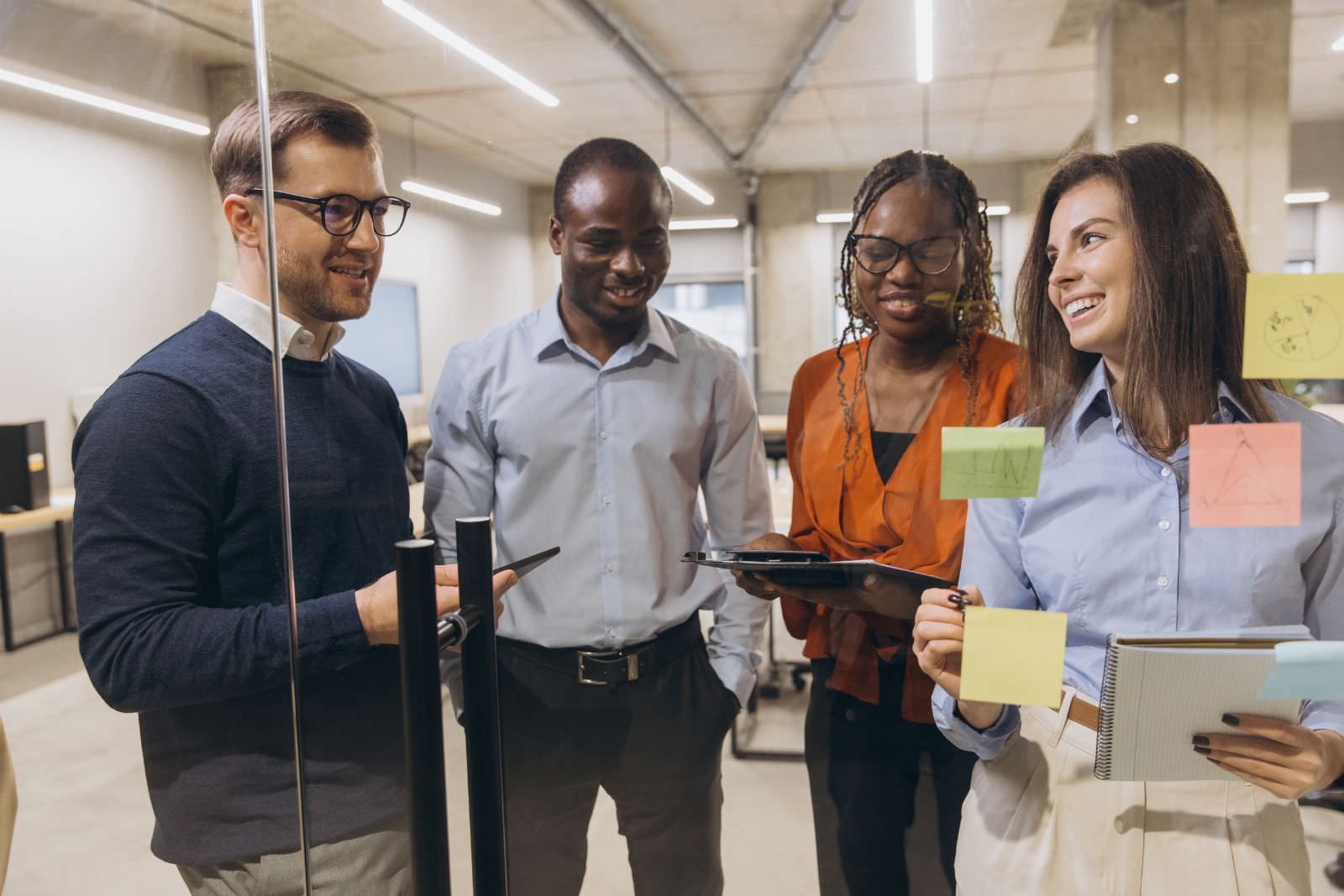 a group of people standing around a design board